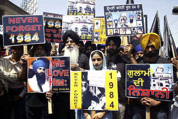 Activists from the Dal Khalsa hold placards during a rally against the 1984 riots