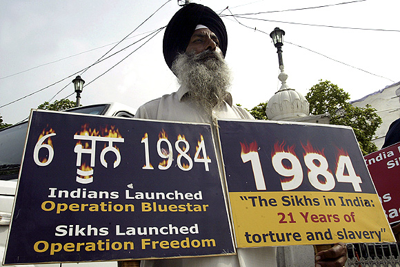 An activist from the Dal Khalsa holds placards against the 1984 riots