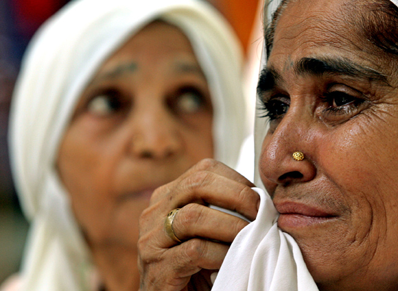 Relatives of victims of the 1984 anti-Sikh riots weep during a protest in New Delhi