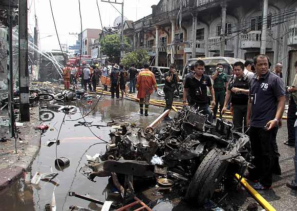 Thai security personnel investigate the site of a bomb attack in southern Thailand's Yala province