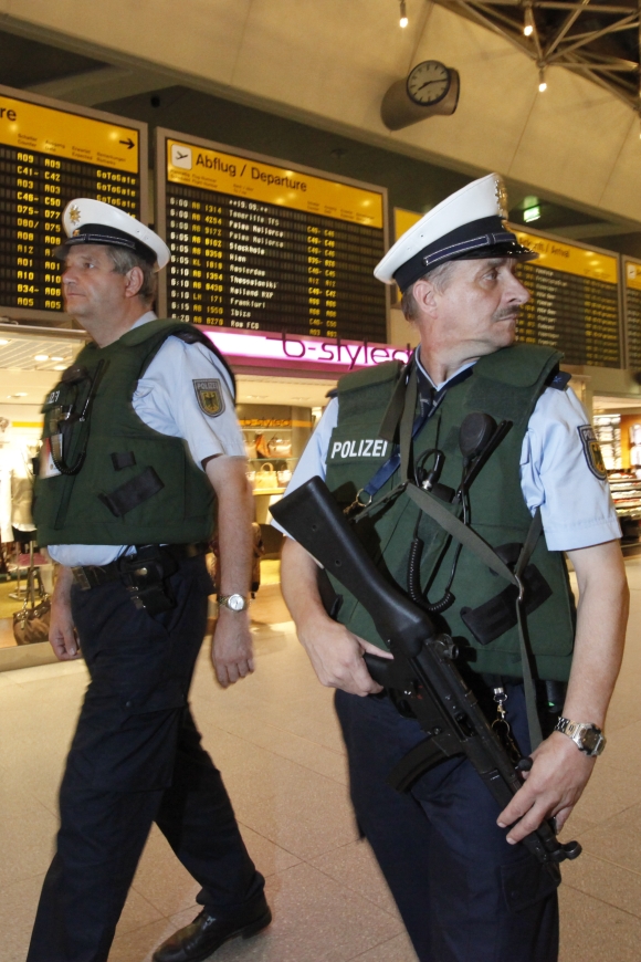 German policemen patrol with bulletproof vests and weapons at Berlin's Tegel airport