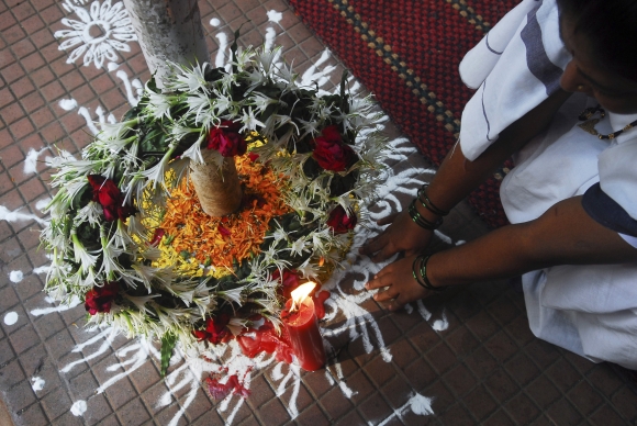 A woman offers prayers at a wreath laid in memory of the victims of the November 26, 2008 attacks in Mumbai
