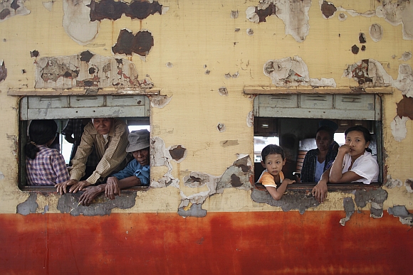 People travelling towards Yangon look through windows as the train stops at Danyingone Station.
