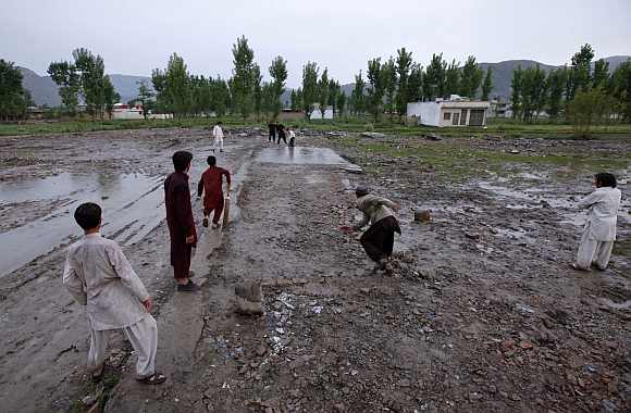 Children play cricket in the rain on the demolished site of the compound of Osama bin Laden, in Abbottabad. Osama bin Laden on May 2, 2011, by a United States special operations military unit in a raid on his compound