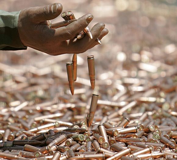 An army soldier displays seized bullets during a news conference in Jammu and Kashmir