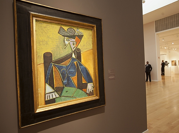 Guards stand near Pablo Picasso's painting