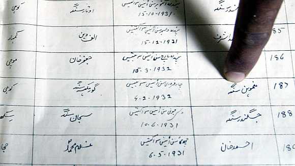 A finger points to the name of Dr Singh on a register record of a primary school in the Pakistan town of Gah, some 80 km southwest of Islamabad