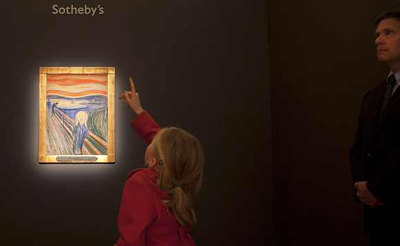 A girl looks over Munch's painting, part of a collection of Impressionist and Modern Art