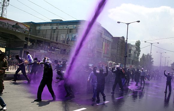 J&K police uses coloured water cannons on striking state government employees to foil their plan to gherao the civil secretariat, in Srinagar on Wednesday.