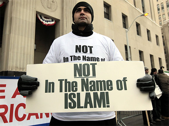 American Ali Sayed holds a sign in front of the Federal court building as he joins a demonstration against terrorism in Detroit