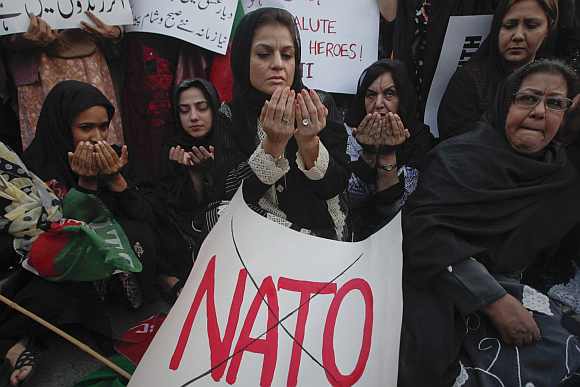 Supporters of Pakistan Tehreek-i-Insaf pray after a demonstration against NATO. US-Pak ties were hit after November's Nato strike