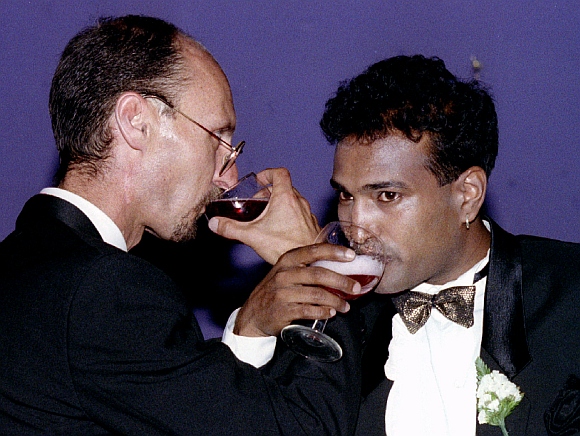 Venash Mooriken (right) and Neil Millard drink a toast after taking their vows in the first cross-racial gay marriage of two HIV-positive men in South Africa