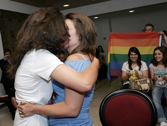 Teresa Paixao (left) and her partner Helena Pires kiss as they get married at a government's registry office in Lisbon