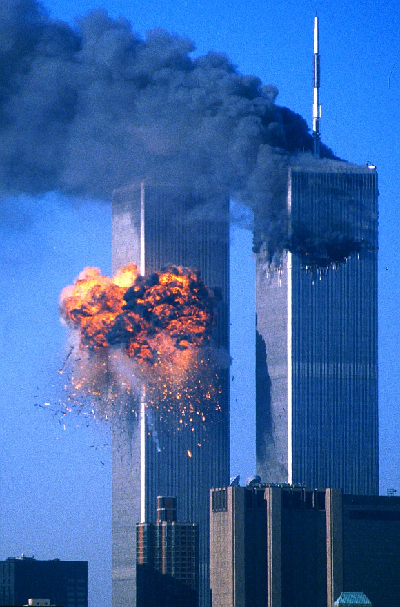 The World Trade Center south tower (left) burst into flames after being struck by hijacked United Airlines Flight 175 as the north tower burns following an earlier attack by a hijacked airliner in New York City on September 11, 2001