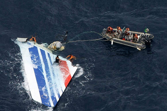 Brazilian Navy sailors pick a piece of debris from Air France flight AF447 out of the Atlantic Ocean, some 1,200 km northeast of Recife, in this handout photo distributed by the Navy June 8, 2009