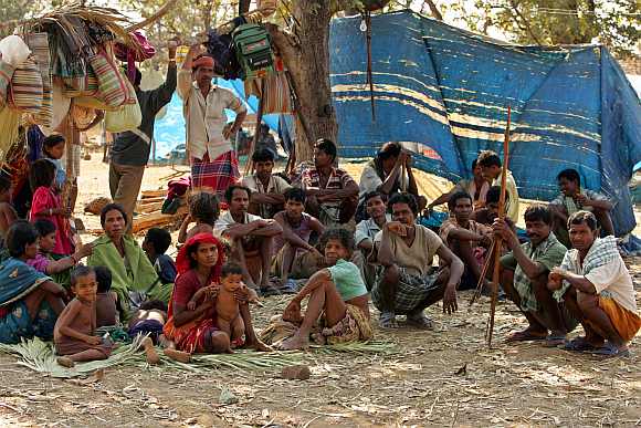 A group of tribe sit in open at a camp run by the Salwa Judum in Dornapal in Chhattisgarh