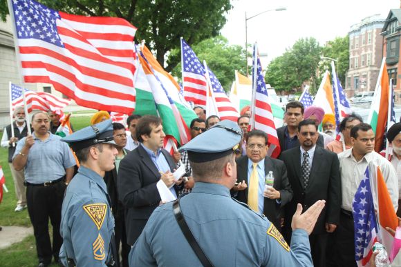 Police officials speak with protestors rallying in support of Dharun Ravi, in New Jersey on Monday