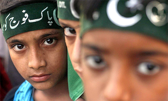 Participants of an anti-America rally wear headbands which read in Urdu 'Salute to Pakistan army'