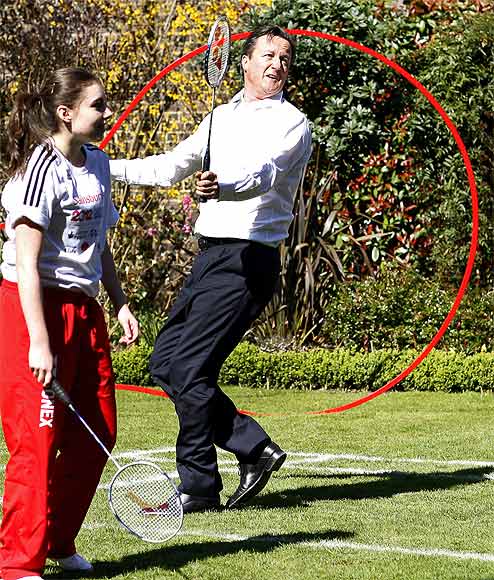 Britain's Prime Minister David Cameron plays a game of badminton in the garden of 10 Downing Street with school athletes and London 2012 Organising Committee chairman Sebastian Coe
