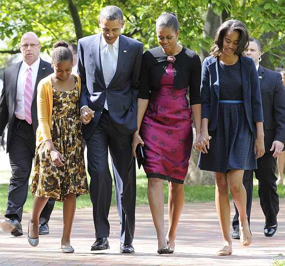 Obama walks from the White House to a church service with his wife Michelle and their daughters Sasha and Malia in Washington