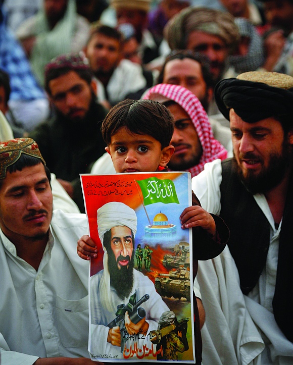 A child holds an image of al-Qaeda leader Osama bin Laden during an anti-American rally organised by the Pakistani religious party Jamiat-e-Ulema-e-Islam in Quetta