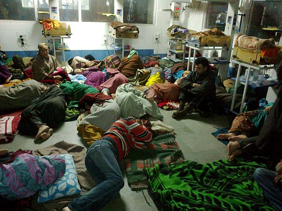 An overcrowded ward at the hospital where attendants of patients are seen jostling for space