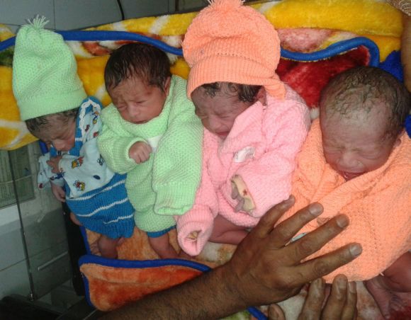 Four infants can be seen sharing a single bed at the G B Pant hospital