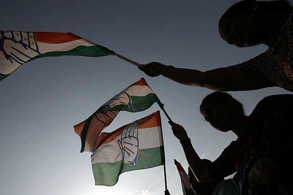 Congress supporters wave the party flag in Bengaluru