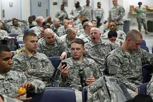 Soldiers from the 10th Mountain Division wait to board a flight to Afghanistan from Fort Drum, New York
