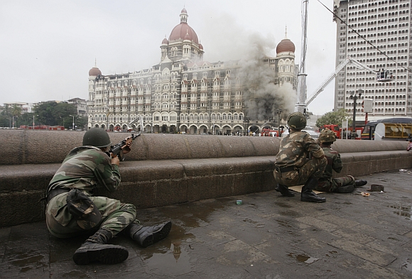 Soldiers take position during a gun battle at the Taj Mahal hotel in Mumbai