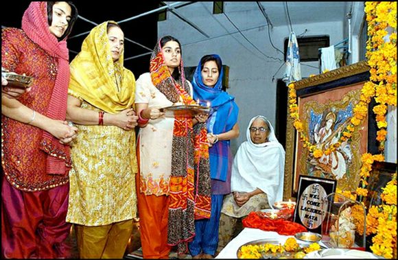 Pakistani Hindu women offer prayers at a temple
