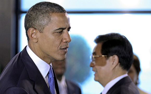 US President Barack Obama walks past his Chinese counterpart Hu Jintao as he arrives for the 2011 G20 Summit in Cannes