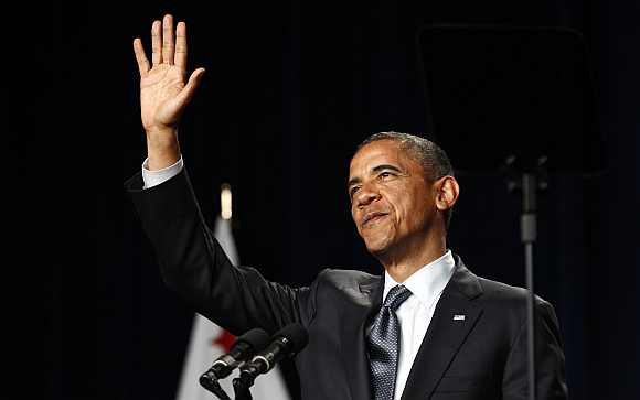 US President Barack Obama waves during a fund raising event at the Fox Theatre in Redwood City, California