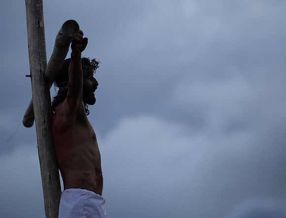 An actor take part in a 'Via Crucis' procession which re-enacts the crucifixion of Jesus Christ