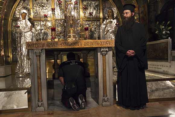 A man prays at the Church of the Holy Sepulchre, the traditional site of Jesus' crucifixion