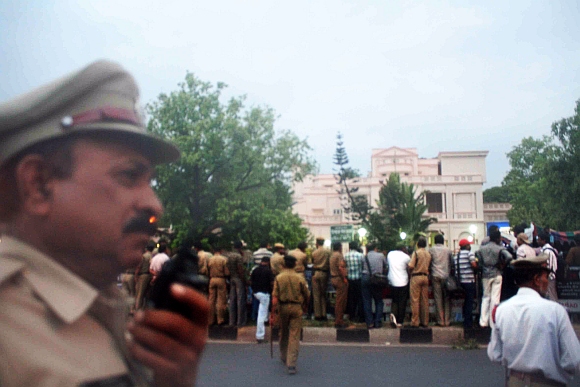 Police and media line up outside the CBI office in Hyderabad