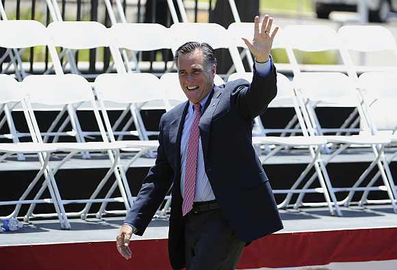 Mitt Romney, US Republican presidential candidate and former Massachusetts governor, waves as he leaves a memorial day ceremony held at the Veterans Museum & Memorial Center in San Diego