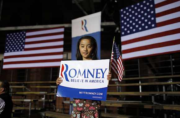 Evelyn Duffy, 9-years-old, a supporter of Romney poses at the site of his primary night rally in Manchester