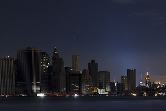 A largely powerless downtown Manhattan stands under a night sky due to a power blackout caused by Hurricane Sandy in New York