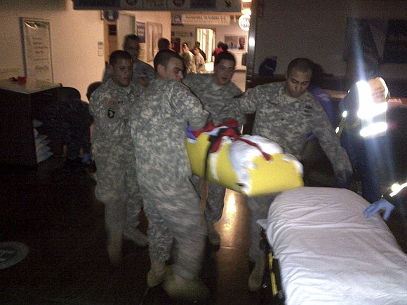 New York Army National Guard soldiers rush to evacuate a patient from Bellevue Hospital in New York