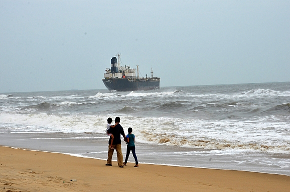 Onlookers watch ship Pratibha Cauvery