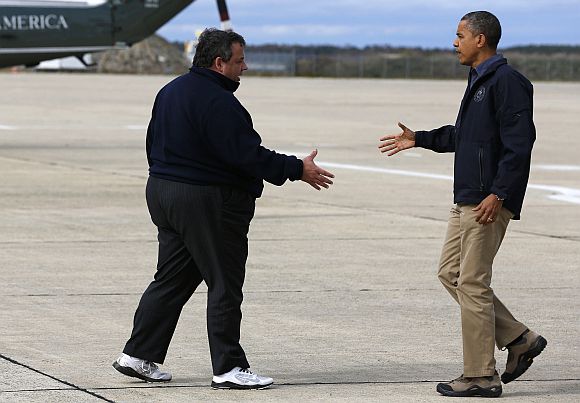 US President Barack Obama shakes hands with New Jersey Governor Chris Christie after he arrives at Atlantic City International Airport in New Jersey before surveying Hurricane Sandy damage