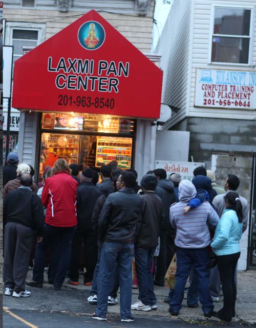 Indian Americans gather outside Laxmi Pan Center in Jersey City on Wednesday