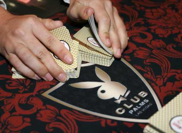 A dealer shuffles cards at a Playboy Club in Las Vegas