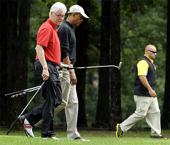 Obama walks the fairway with Clinton as they play golf at Andrews Air Force Base