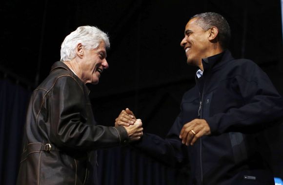 Bill Clinton introduces US President Obama during a campaign rally in Bristow, Virginia, on Saturday