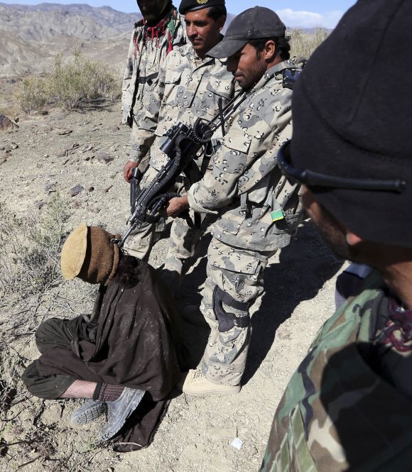 Afghan border policemen with a detained suspected Taliban fighter near the town of Walli Was in Paktika province, near the border with Pakistan.