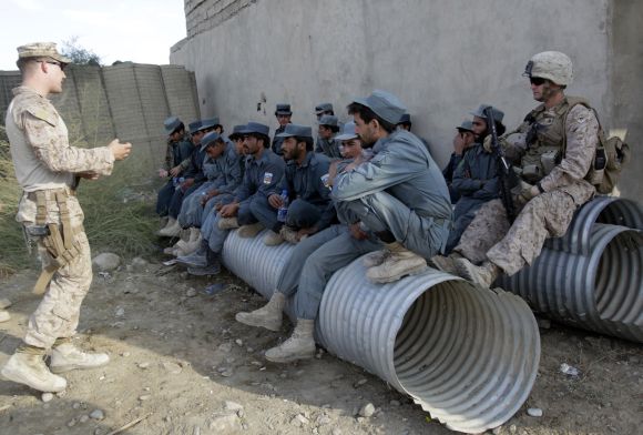 US Marine Corporal Anthony Woltz of Police Advisor Team, 2nd Battalion, 7th Marines Regiment gives a lecture on anti-terrorist tactics to police trainees during a basic police training course at Combat Outpost Musa Qal-Ah in Helmand province in southwestern Afghanistan