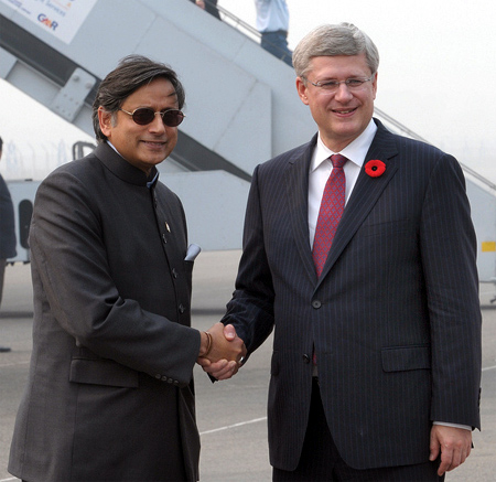 Prime Minister of Canada Stephen Harper being received by the Minister of State for Human Resource Development Shashi Tharoor in New Delhi
