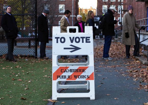 People wait in line to vote during the US presidential election in Cambridge, Massachusetts, on Tuesday